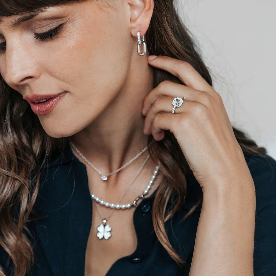 Channel set linked earrings worn by a model
