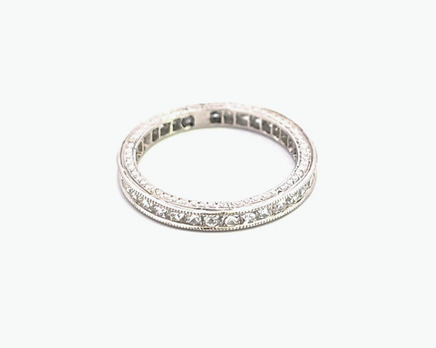 Floral-inspired diamond eternity ring in silver or white gold, featuring small round diamonds set in a continuous pattern along the band – Sample Image.