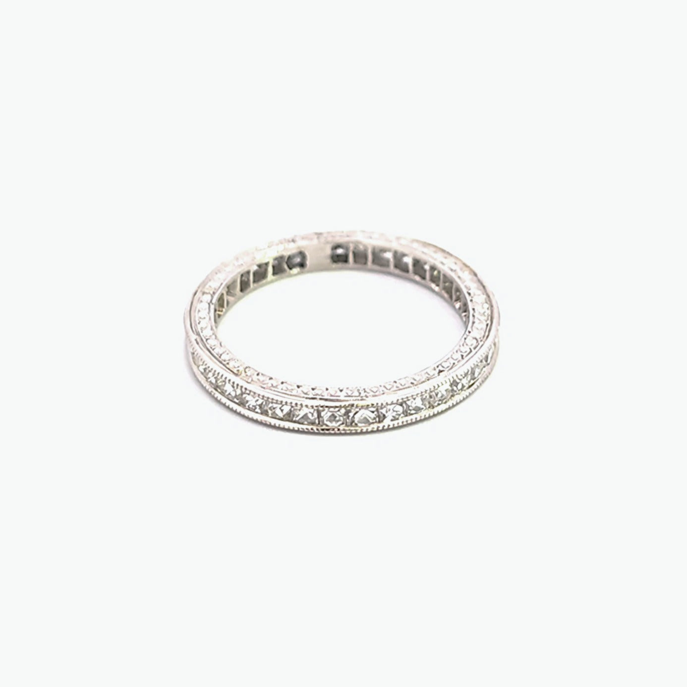 Floral-inspired diamond eternity ring in silver or white gold, featuring small round diamonds set in a continuous pattern along the band – Sample Image.