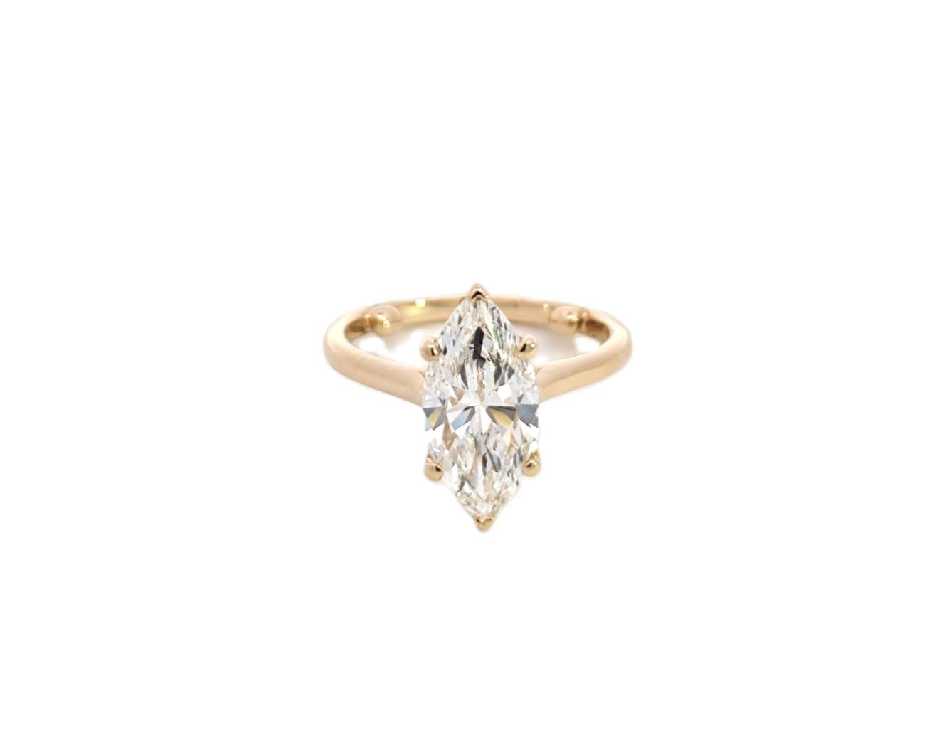 Gold engagement ring featuring a pear-shaped diamond set on a polished yellow gold band, displayed on a clean white background. Elegant and modern design, ideal for a striking solitaire look. - Sample Image