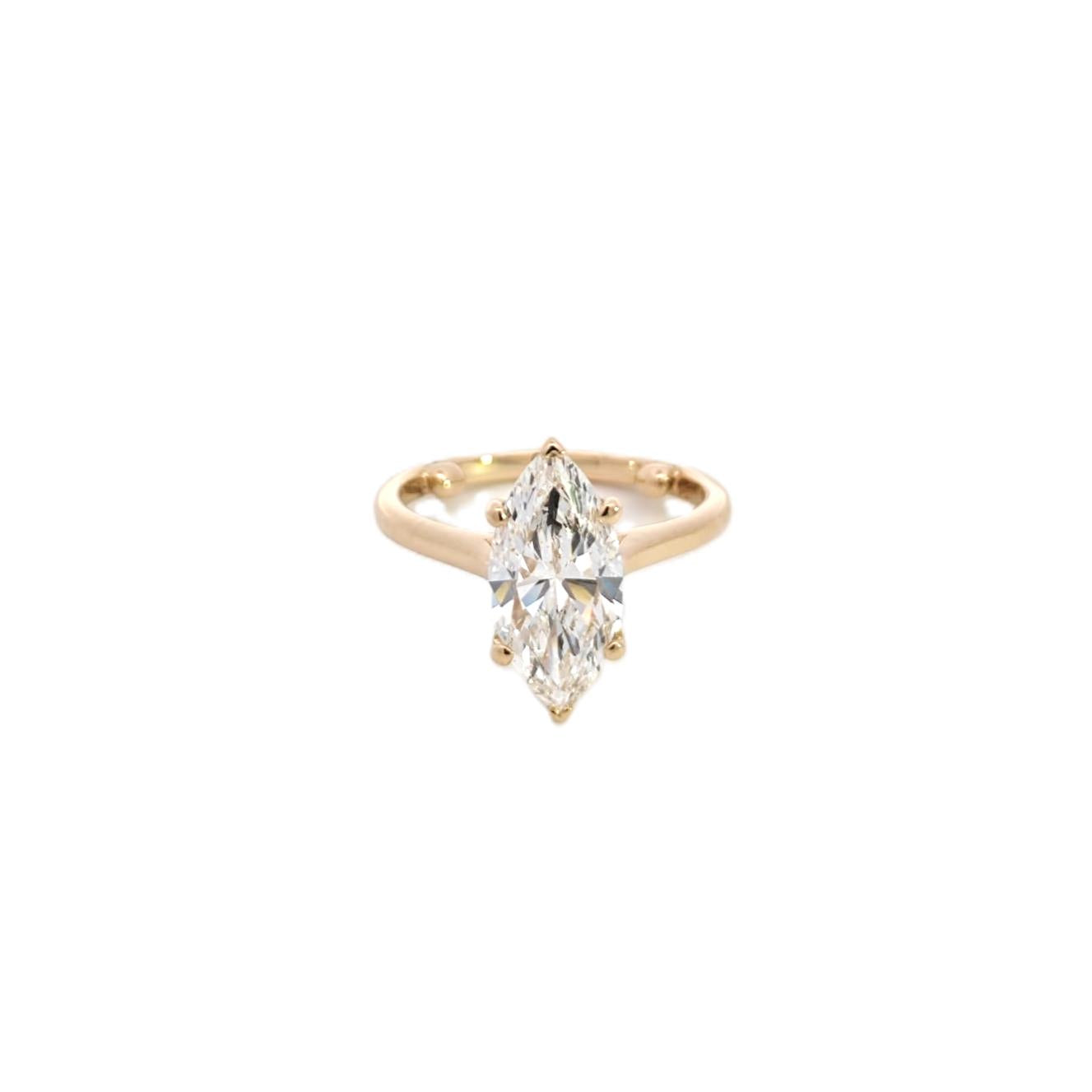 Gold engagement ring featuring a pear-shaped diamond set on a polished yellow gold band, displayed on a clean white background. Elegant and modern design, ideal for a striking solitaire look. - Sample Image