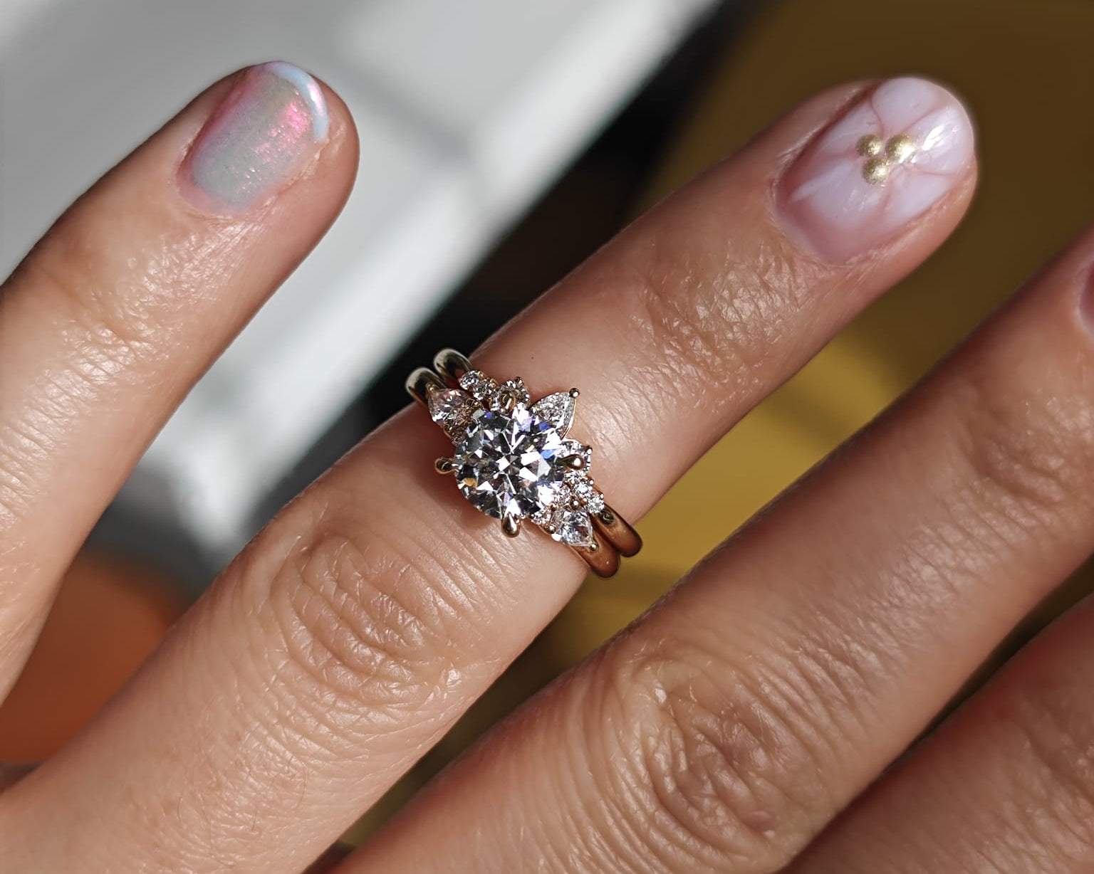 Two-ring set with a central gemstone and smaller accent stones. Elegant engagement and wedding ring combination. - Sample Image
