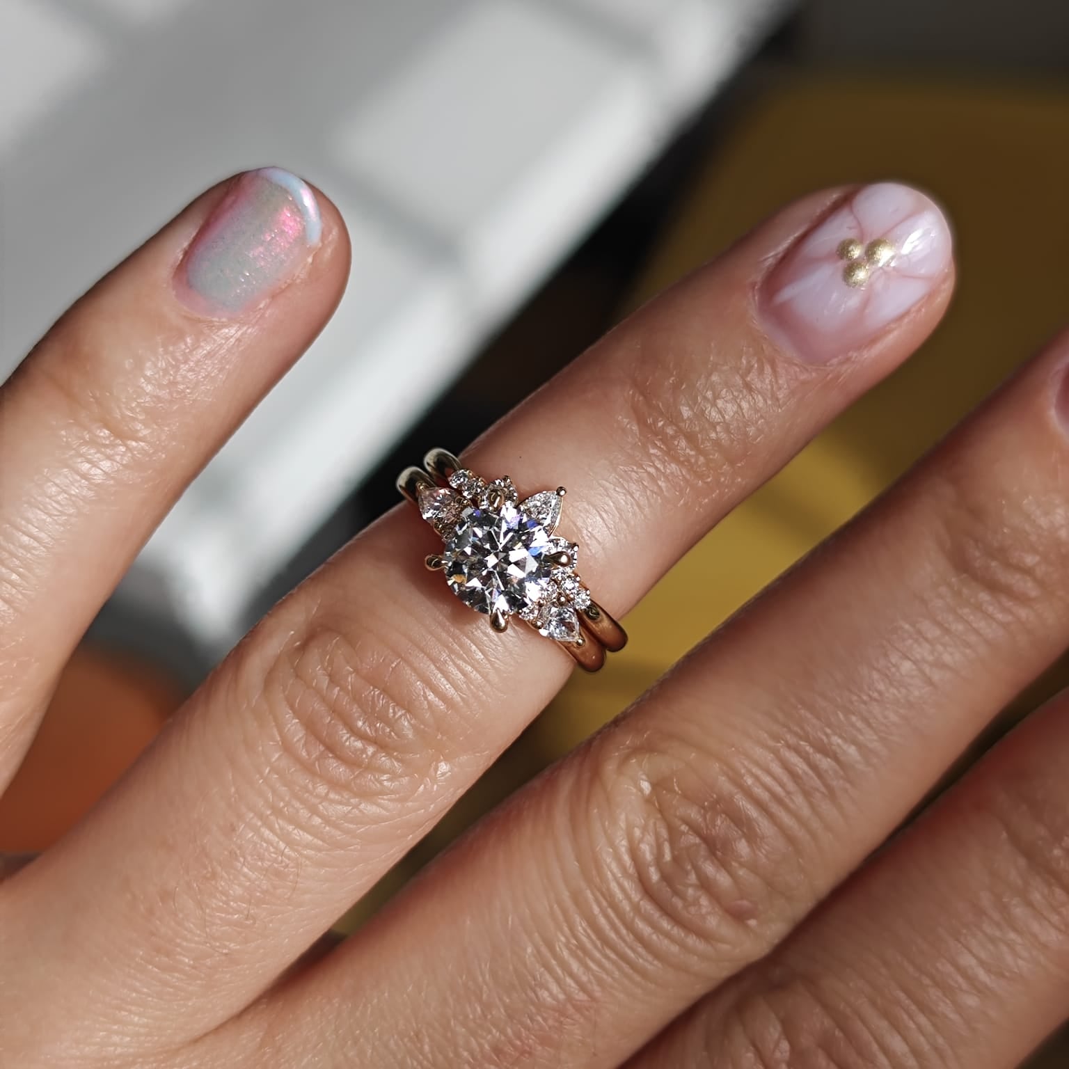 Two-ring set with a central gemstone and smaller accent stones. Elegant engagement and wedding ring combination. - Sample Image