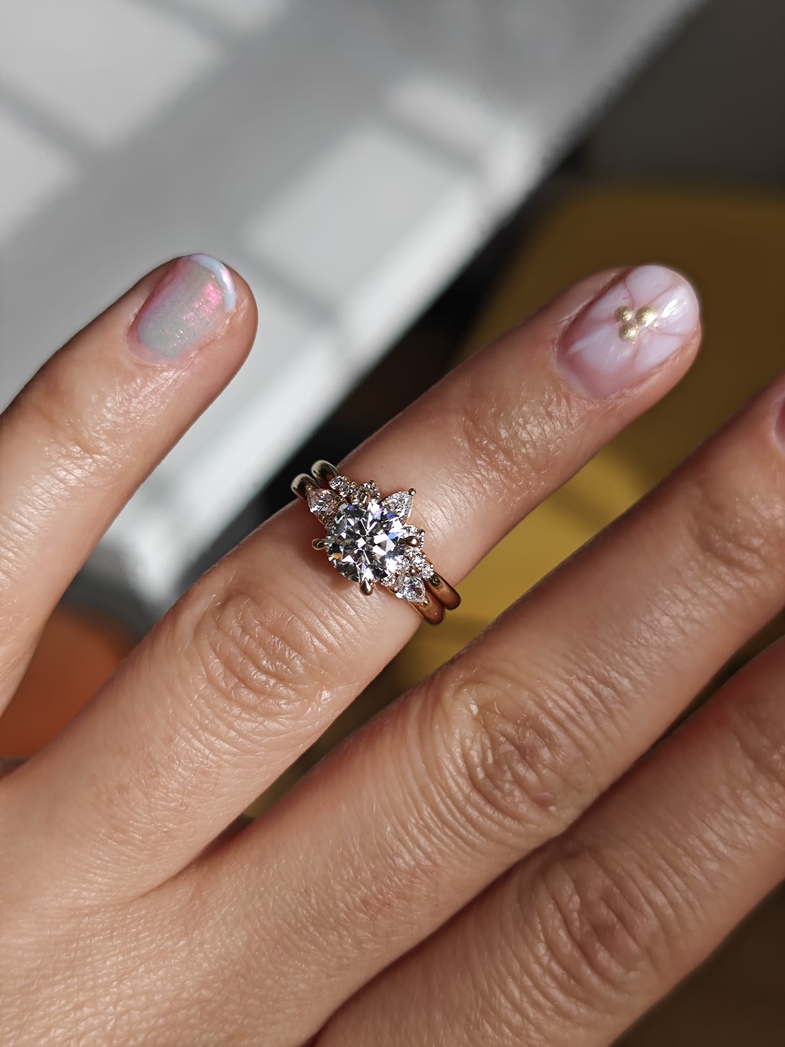 Two-ring set with a central gemstone and smaller accent stones. Elegant engagement and wedding ring combination. - Sample Image