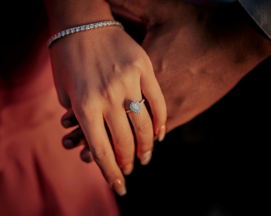 a photo of a high set engagement ring being worn