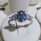 Platinum 1ct Oval Cut Blue Diamond Trilogy Engagement Ring-The Diamond Setter