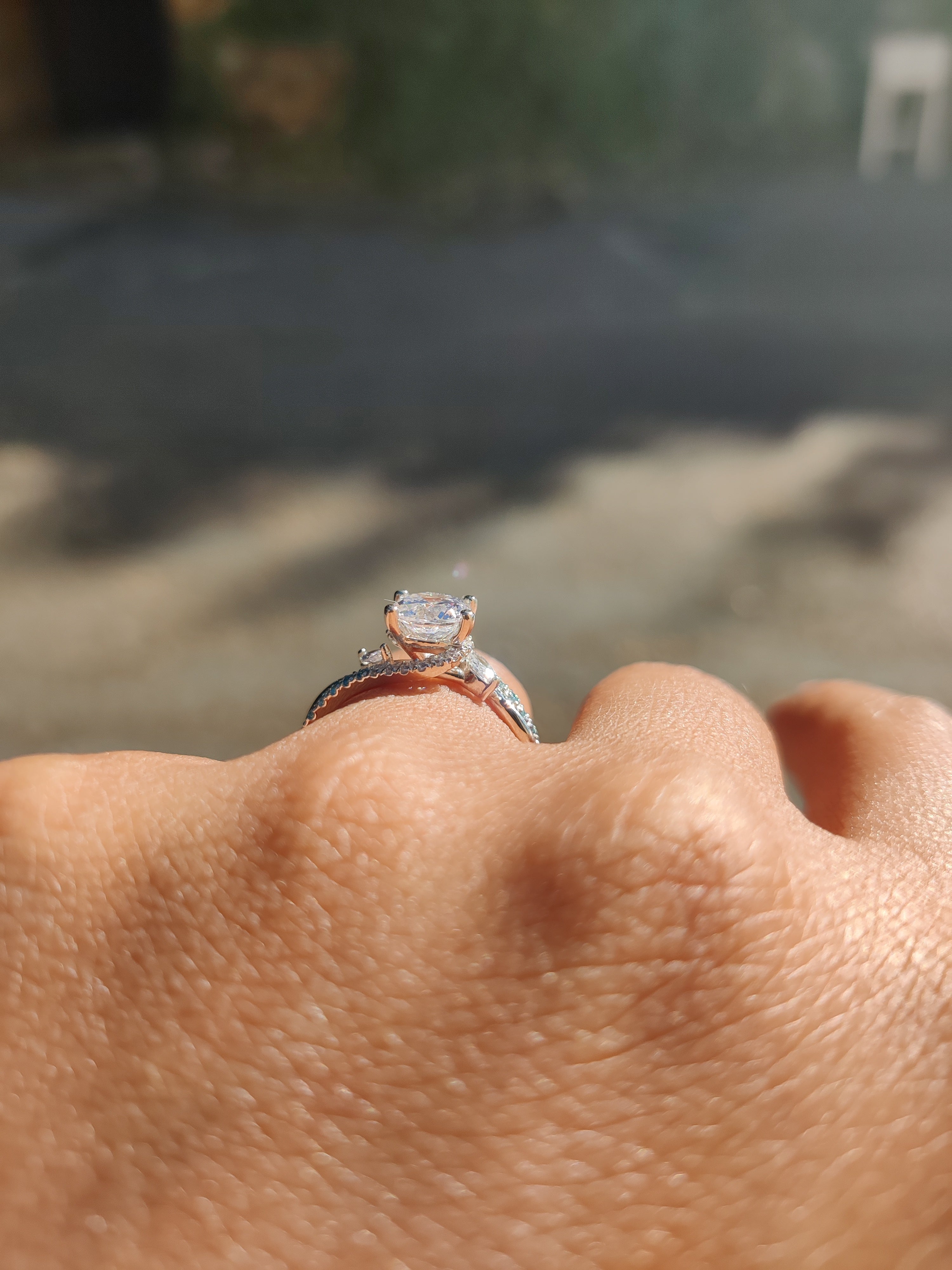 Round French-Set Bypass Engagement Ring with blue diamond accents-The Diamond Setter