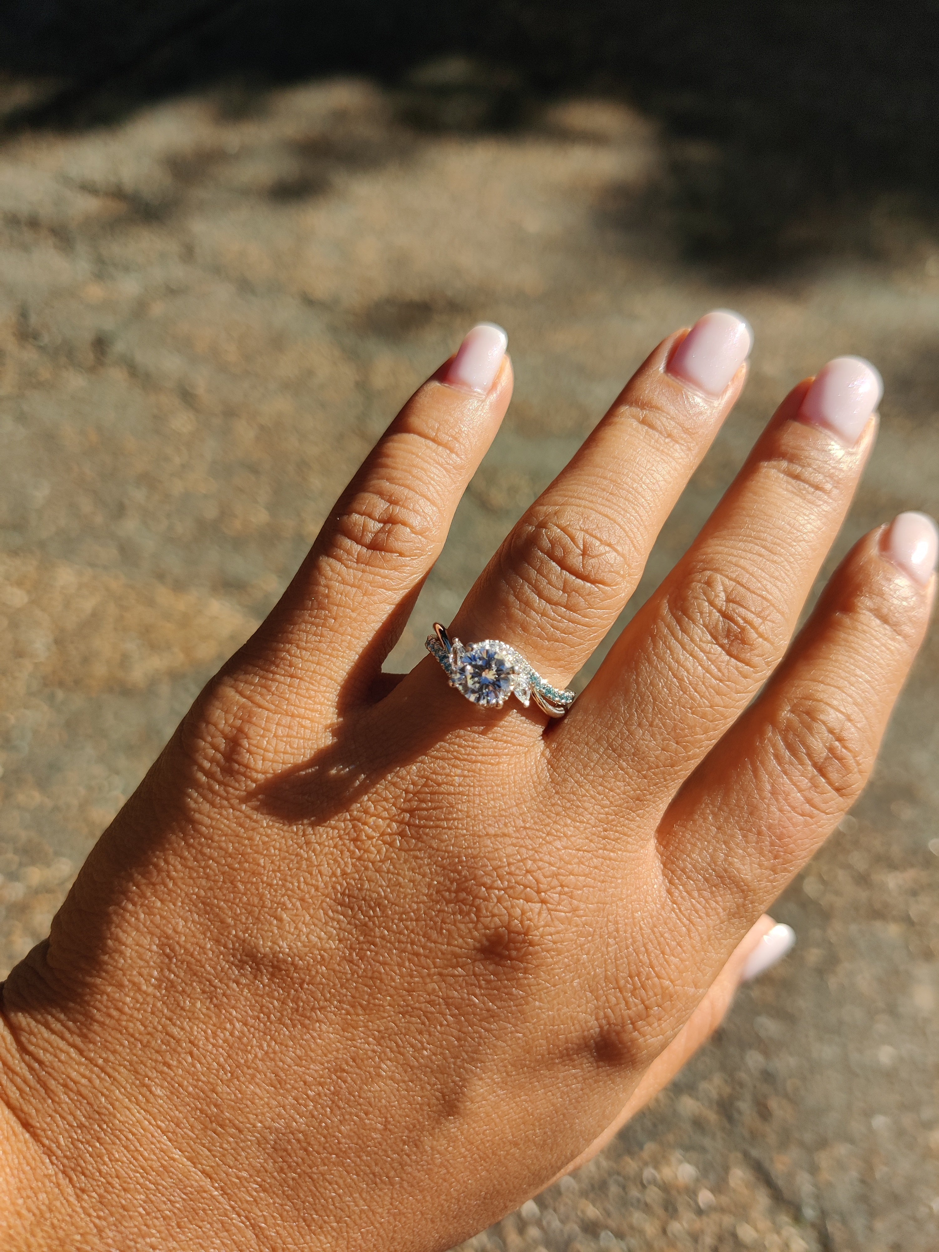 Round French-Set Bypass Engagement Ring with blue diamond accents-The Diamond Setter